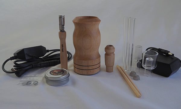 This is Ed's TnT WoodScents AromaLog shown in Maple wood available at Ritual. The full kit is pictured including power cord and adapter, glass stems, glass water pipe adapter, glass aroma bowl, o-rings, Maple stem and water pipe adapter, screens, and Ed's Bomb Ass Butter.